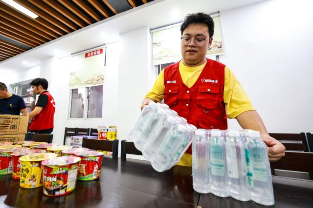 (260711) -- WENZHOU, July 11, 2026 (Xinhua) -- A volunteer arranges supplies at a temporary shelter, which hosts 20 local villagers affected by Typhoon Bavi, in Yongjia County of Wenzhou, east China's Zhejiang Province, July 10, 2026. Zhejiang Province in east China raised its typhoon emergency response to the highest level on Saturday as Typhoon Bavi, the 9th typhoon of 2026, barrels toward the country's eastern coast, triggering widespread disaster prevention efforts across multiple provincial-level regions. 
  According to Zhejiang Meteorological Observatory, the severe typhoon was located some 489 km off the coast of the province's city of Wenzhou as of 9 a.m. on Saturday, packing strong-typhoon-level winds near its center. It is forecast to move northwest at a speed of 30 to 35 km per hour and make landfall in Zhejiang around midnight. (Xinhua/Jiang Han)