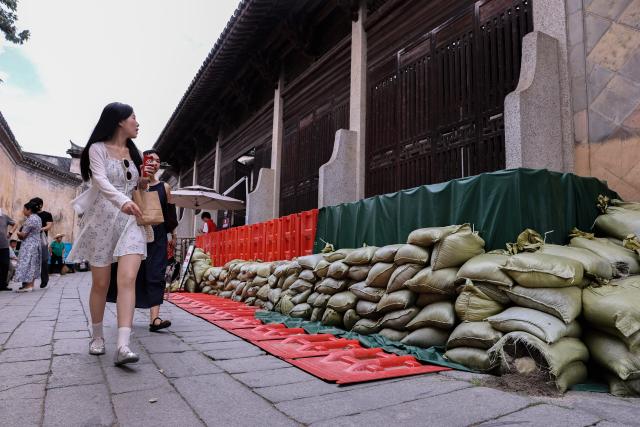 (260711) -- BEIJING, July 11, 2026 (Xinhua) -- This photo taken on July 11, 2026 shows flood-control sandbags at Chengkan ancient village in Huizhou District of Huangshan City, east China's Anhui Province. Chinese authorities on Saturday intensified emergency response measures with Typhoon Bavi set to slam into the country's eastern coast, resulting in meteorological, water resources, transport and emergency management authorities issuing alerts and reinforcing flood-control efforts ahead of the expected landfall.
   The country's State Flood Control and Drought Relief Headquarters activated a Level-IV emergency response for flood and typhoon control in Shanghai, Jiangsu, Anhui and Jiangxi, all in east China, as well as southwest China's Sichuan Province, according to the Ministry of Emergency Management. (Xinhua/Chang Nengjia)