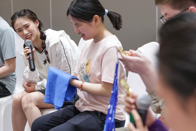(260713) -- BEIJING, July 13, 2026 (Xinhua) -- World diving gold medalist Chen Yuxi (1st L) attends a summer camp event in Beijing, capital of China, July 12, 2026.
  UNICEF China on Sunday invited world diving gold medalist Chen Yuxi to a summer camp event here attended by children with visual impairments, in an effort to help children with disabilities discover their potential and raise public awareness of protecting their rights. (Xinhua/Zhang Yuwei)