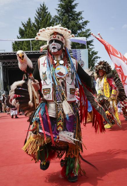 (260713) -- NORTH VANCOUVER, July 13, 2026 (Xinhua) -- Members of Indigenous communities perform during the Squamish Nation Youth Pow-Wow in North Vancouver, British Columbia, Canada, on July 12, 2026. The annual event brought together Indigenous youth, dancers, drummers and community members to celebrate First Nations cultures, traditions and heritage through traditional songs, dances and ceremonies. (Photo by Liang Sen/ Xinhua)
