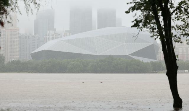 (260713) -- SHENYANG, July 13, 2026 (Xinhua) -- This photo taken on July 13, 2026 shows the swollen Hunhe River in Shenyang, northeast China's Liaoning Province. Due to recent downpours, the water level at the Shenyang Hydrological Station on the Hunhe River reached 37.99 meters. (Xinhua/Yang Qing)