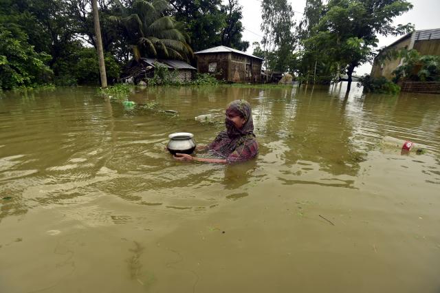 (260713) -- COX'S BAZAR, July 13, 2026 (Xinhua) -- A woman wades in floodwater in Cox's Bazar district, Bangladesh, July 12, 2026. Floods that have swept parts of Bangladesh for about a week have killed 51 people, said a senior official on Sunday.
   According to the latest daily disaster situation report released by the country's Ministry of Disaster Management and Relief, more than 1.02 million people were marooned by floods in seven out of the country's total 64 districts. (Photo by Habibur Rahman/Xinhua)
