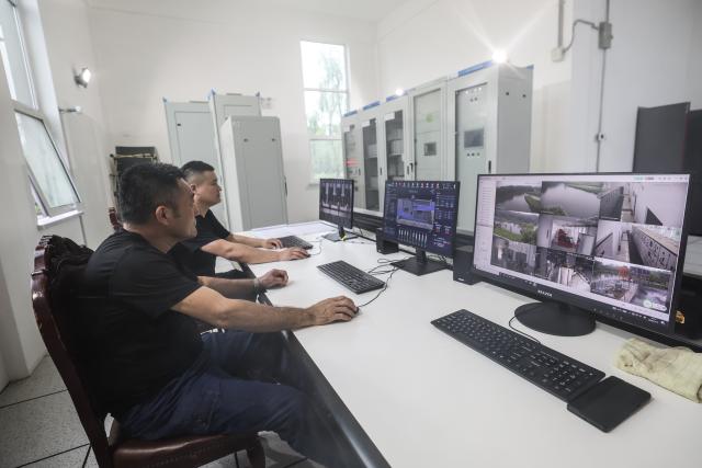 (260713) -- BEIJING, July 13, 2026 (Xinhua) -- Staff members monitor equipment operations at a pump-and-sluice station along Taiping River in Panjin City, northeast China's Liaoning Province, July 13, 2026. As extreme weather has swept across multiple regions across China in recent days, local authorities have implemented disaster prevention and relief measures to safeguard people's lives and property. (Xinhua/Pan Yulong)