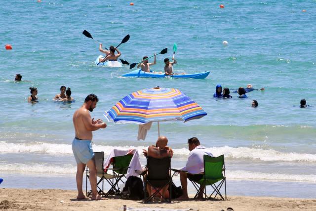 (260713) -- TYRE, July 13, 2026 (Xinhua) -- People enjoy themselves on a beach in Tyre, Lebanon, July 12, 2026. (Photo by Ali Hashisho/Xinhua)