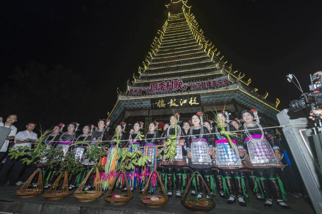 (260713) -- CONGJIANG, July 13, 2026 (Xinhua) -- People of the Dong ethnic group perform during a musical event in Congjiang County of southwest China's Guizhou Province, July 12, 2026. The event featuring performing arts of the Dong ethnic group and local specialty foods was held here on Sunday, attracting hundreds of tourists. (Photo by Wu Dejun/Xinhua)