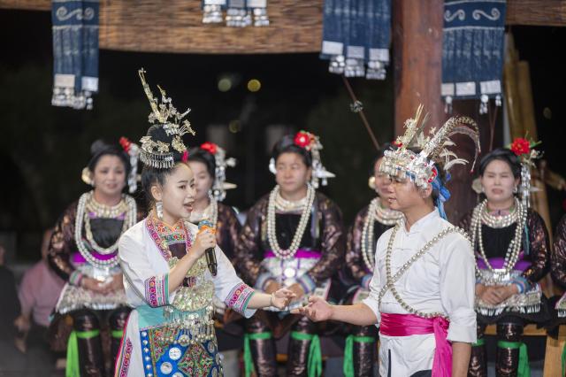 (260713) -- CONGJIANG, July 13, 2026 (Xinhua) -- People of the Dong ethnic group perform during a musical event in Congjiang County of southwest China's Guizhou Province, July 12, 2026. The event featuring performing arts of the Dong ethnic group and local specialty foods was held here on Sunday, attracting hundreds of tourists. (Photo by Wu Dejun/Xinhua)