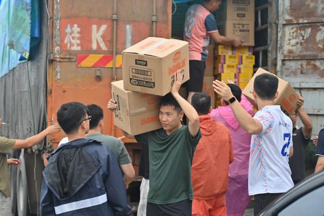 (260713) -- NANNING, July 13, 2026 (Xinhua) -- Volunteers transfer relief supplies at Xijiang education park in Guigang City, south China's Guangxi Zhuang Autonomous Region, July 8, 2026. Triggered by Typhoon Maysak, heavy downpours battered multiple areas in south China's Guangxi Zhuang Autonomous Region.
   Rescue operation is underway in Guangxi, with rescuers from different parts of the country actively involved in the disaster rescue and relief efforts. (Xinhua/Zhou Hua)