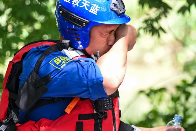 (260713) -- NANNING, July 13, 2026 (Xinhua) -- A rescue worker wipes sweat off his face in Guigang City, south China's Guangxi Zhuang Autonomous Region, July 10, 2026. Triggered by Typhoon Maysak, heavy downpours battered multiple areas in south China's Guangxi Zhuang Autonomous Region.
   Rescue operation is underway in Guangxi, with rescuers from different parts of the country actively involved in the disaster rescue and relief efforts. (Xinhua/Cao Yiming)