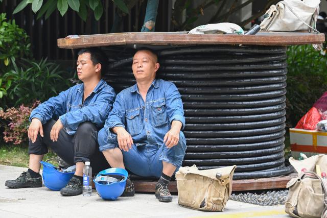 (260713) -- NANNING, July 13, 2026 (Xinhua) -- Two power line repairing workers dispatched from southwest China's Guizhou lean against coiled power cable for a short break in Guigang City, south China's Guangxi Zhuang Autonomous Region, July 10, 2026. Triggered by Typhoon Maysak, heavy downpours battered multiple areas in south China's Guangxi Zhuang Autonomous Region.
   Rescue operation is underway in Guangxi, with rescuers from different parts of the country actively involved in the disaster rescue and relief efforts. (Xinhua/Cao Yiming)