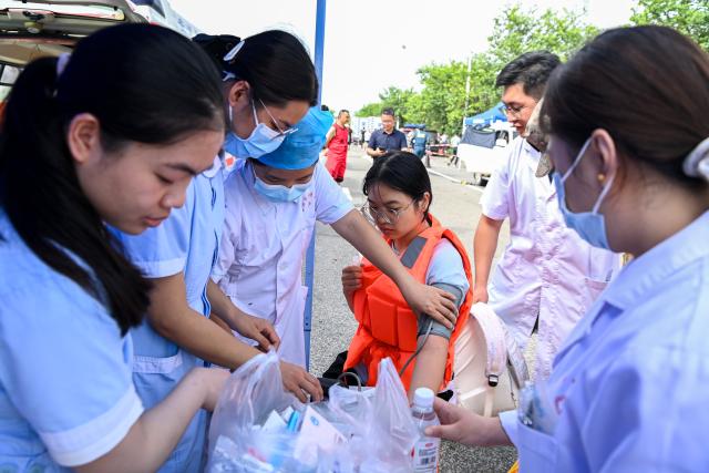 (260713) -- NANNING, July 13, 2026 (Xinhua) -- Medical workers conduct medical examinations for students who have been just evacuated in Guigang City, south China's Guangxi Zhuang Autonomous Region, July 9, 2026. Triggered by Typhoon Maysak, heavy downpours battered multiple areas in south China's Guangxi Zhuang Autonomous Region.
   Rescue operation is underway in Guangxi, with rescuers from different parts of the country actively involved in the disaster rescue and relief efforts. (Xinhua/Cao Yiming)