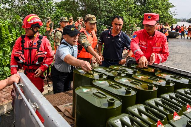 (260713) -- NANNING, July 13, 2026 (Xinhua) -- Rescue workers transfer fuel in Guigang City, south China's Guangxi Zhuang Autonomous Region, July 9, 2026. Triggered by Typhoon Maysak, heavy downpours battered multiple areas in south China's Guangxi Zhuang Autonomous Region.
   Rescue operation is underway in Guangxi, with rescuers from different parts of the country actively involved in the disaster rescue and relief efforts. (Xinhua/Cao Yiming)