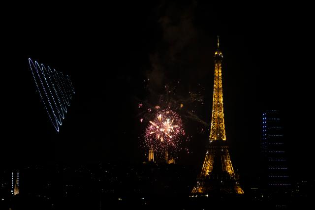 (260713) -- PARIS, July 13, 2026 (Xinhua) -- Fireworks illuminate the sky near the Eiffel Tower during the Bastille Day celebrations in Paris, France, on July 13, 2026. (Xinhua/Wu Huiwo)