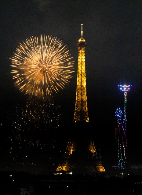 (260713) -- PARIS, July 13, 2026 (Xinhua) -- Fireworks illuminate the sky near the Eiffel Tower during the Bastille Day celebrations in Paris, France, on July 13, 2026. (Xinhua/Wu Huiwo)