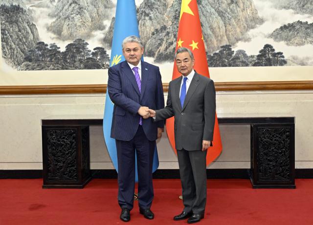 (260713) -- BEIJING, July 13, 2026 (Xinhua) -- Chinese Foreign Minister Wang Yi, also a member of the Political Bureau of the Communist Party of China (CPC) Central Committee, holds talks with Kazakhstan's Minister of Foreign Affairs Yermek Kosherbayev in Beijing, capital of China, July 13, 2026. (Xinhua/Yin Bogu)