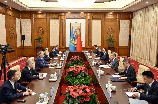 (260713) -- BEIJING, July 13, 2026 (Xinhua) -- Chinese Foreign Minister Wang Yi, also a member of the Political Bureau of the Communist Party of China (CPC) Central Committee, holds talks with Kazakhstan's Minister of Foreign Affairs Yermek Kosherbayev in Beijing, capital of China, July 13, 2026. (Xinhua/Yin Bogu)