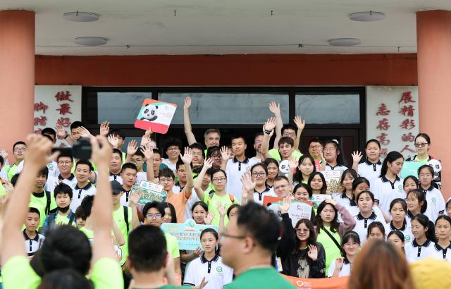(260714) -- ANSHAN, July 14, 2026 (Xinhua) -- Members of a study tour pose for photos with local students in Xiuyan Man Autonomous County, northeast China's Liaoning Province, July 12, 2026. Nearly 50 international teachers and students from five countries, including Mongolia, Greece, Thailand, Vietnam and Indonesia, joined the study tour, visiting modern agricultural production sites in northern China and enjoying immersive experiences of traditional Chinese culture. (Xinhua/Li Gang)