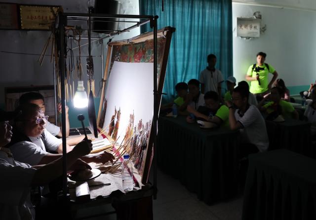 (260714) -- ANSHAN, July 14, 2026 (Xinhua) -- Members of a study tour watch a shadow puppetry performance in Xiuyan Man Autonomous County, northeast China's Liaoning Province, July 12, 2026. Nearly 50 international teachers and students from five countries, including Mongolia, Greece, Thailand, Vietnam and Indonesia, joined the study tour, visiting modern agricultural production sites in northern China and enjoying immersive experiences of traditional Chinese culture. (Xinhua/Li Gang)
