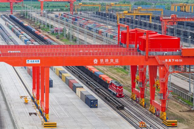 (260714) -- HARBIN, July 14, 2026 (Xinhua) -- A drone photo taken on June 24, 2026 shows a China-Europe freight train undergoing cargo transshipment at Tongjiang North Railway Station in Tongjiang, northeast China's Heilongjiang Province. China Railway Harbin Group Co., Ltd. has advanced the development of digital port systems and railway express services while continuously improving connectivity among port infrastructure facilities. These efforts have enhanced the efficiency and capacity of the eastern corridor of the China-Europe freight train service. 
   As of June 2026, the cumulative number of China-Europe Railway Express trips via the eastern corridor had exceeded 40,000.
   The eastern corridor, consisting of three major railway ports of Manzhouli, Suifenhe and Tongjiang, has so far connected more than 60 Chinese cities with 14 European countries through 27 regular routes, serving as a vivid example of efforts to promote high-quality Belt and Road cooperation. (Xinhua/Zhang Tao)