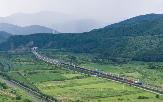 (260714) -- HARBIN, July 14, 2026 (Xinhua) -- An aerial drone photo taken on July 13, 2026 shows a China-Europe freight train pulling out of the Suifenhe Railway Port in Suifenhe, northeast China's Heilongjiang Province. China Railway Harbin Group Co., Ltd. has advanced the development of digital port systems and railway express services while continuously improving connectivity among port infrastructure facilities. These efforts have enhanced the efficiency and capacity of the eastern corridor of the China-Europe freight train service. 
   As of June 2026, the cumulative number of China-Europe Railway Express trips via the eastern corridor had exceeded 40,000.
   The eastern corridor, consisting of three major railway ports of Manzhouli, Suifenhe and Tongjiang, has so far connected more than 60 Chinese cities with 14 European countries through 27 regular routes, serving as a vivid example of efforts to promote high-quality Belt and Road cooperation. (Photo by Qu Yiwei/Xinhua)