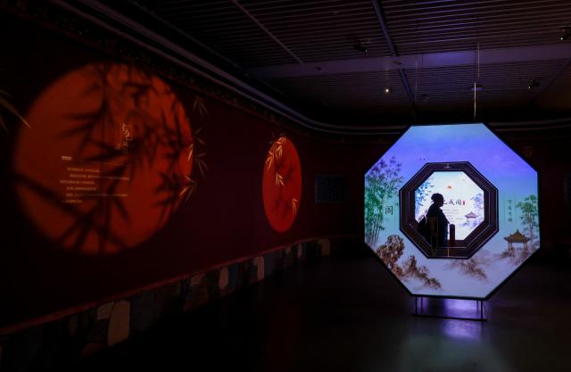(260714) -- BEIJING, July 14, 2026 (Xinhua) -- A visitor is pictured during "A Garden Within: An Immersive Light and Shadow Exhibition of the Qianlong Garden" at National Museum of Classic Books in Beijing, capital of China, July 14, 2026. The exhibition, which features multiple immersive scenarios and interactive installations, is held here from July 9 to Dec. 6.
   The Qianlong Garden, also known as the Garden of the Palace of Tranquil Longevity, was built by Emperor Qianlong (1711-1799) of Qing Dynasty (1644-1911) as a private retreat for his later years in the Forbidden City, or today's Palace Museum. (Xinhua/Yin Gang)