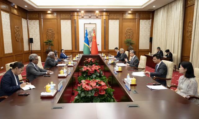 (260714) -- BEIJING, July 14, 2026 (Xinhua) -- Chinese Foreign Minister Wang Yi, also a member of the Political Bureau of the Communist Party of China Central Committee, holds talks with Rick Houenipwela, minister for foreign affairs and external trade of the Solomon Islands, in Beijing, capital of China, July 14, 2026. (Xinhua/Li Tao)