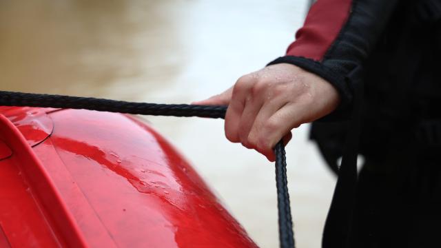 (260714) -- NANNING, July 14, 2026 (Xinhua) -- A rescuer hauls a rubber inflatable boat through a waterlogged area to rescue trapped residents in Napeng Town, Qinzhou City, south China's Guangxi Zhuang Autonomous Region, July 8, 2026. Efforts are underway to support flood relief and recovery in Guangxi, which has been hit by severe rainstorms and flooding caused by Typhoon Maysak. (Xinhua/Zhang Ailin)
