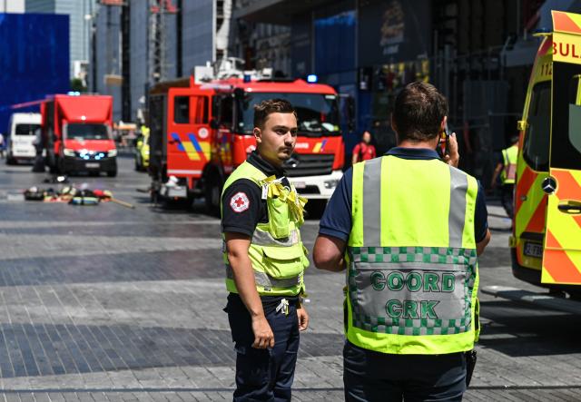 (260714) -- BRUSSELS, July 14, 2026 (Xinhua) -- Emergency personnel work near the fire site of the Oxy building on De Brouckere Square, Brussels, Belgium, July 14, 2026. Multiple people have died on Tuesday in a fire at the well-known Oxy building on De Brouckere Square, in the center of Brussels.
   According to local media, 6 people are still missing. The fire brigade has deployed en masse for a major search and rescue operation. (Xinhua/Peng Ziyang)