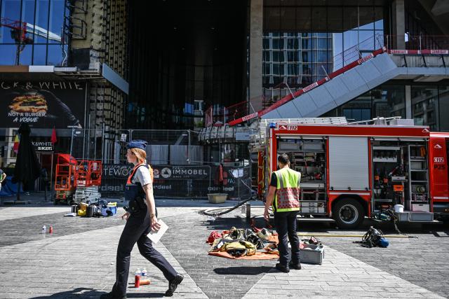 (260714) -- BRUSSELS, July 14, 2026 (Xinhua) -- This photo taken on July 14, 2026 shows the fire site of the Oxy building on De Brouckere Square, Brussels, Belgium. Multiple people have died on Tuesday in a fire at the well-known Oxy building on De Brouckere Square, in the center of Brussels.
   According to local media, 6 people are still missing. The fire brigade has deployed en masse for a major search and rescue operation. (Xinhua/Peng Ziyang)