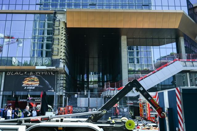 (260714) -- BRUSSELS, July 14, 2026 (Xinhua) -- This photo taken on July 14, 2026 shows the fire site of the Oxy building on De Brouckere Square, Brussels, Belgium. Multiple people have died on Tuesday in a fire at the well-known Oxy building on De Brouckere Square, in the center of Brussels.
   According to local media, 6 people are still missing. The fire brigade has deployed en masse for a major search and rescue operation. (Xinhua/Peng Ziyang)