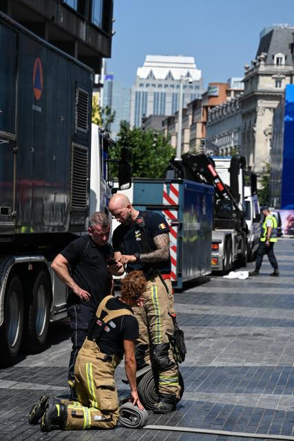 (260714) -- BRUSSELS, July 14, 2026 (Xinhua) -- Firefighters work near the fire site of the Oxy building on De Brouckere Square, Brussels, Belgium, July 14, 2026. Multiple people have died on Tuesday in a fire at the well-known Oxy building on De Brouckere Square, in the center of Brussels.
   According to local media, 6 people are still missing. The fire brigade has deployed en masse for a major search and rescue operation. (Xinhua/Peng Ziyang)