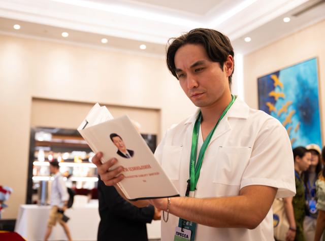 (260714) -- BISHKEK, July 14, 2026 (Xinhua) -- A journalist reads a copy of "Xi Jinping: The Governance of China" at an event promoting the fifth volume of the book, in Bishkek, the capital of Kyrgyzstan, July 13, 2026. An event promoting the fifth volume of "Xi Jinping: The Governance of China" was held here on Monday. (Xinhua/Li Renzi)