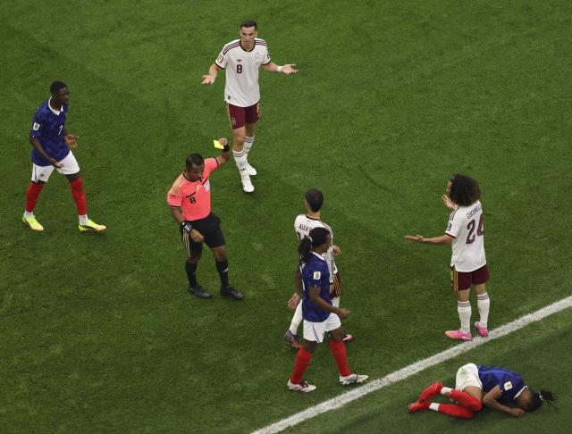 (260715) -- DALLAS, July 15, 2026 (Xinhua) -- Referee Ivan Barton (2nd L) shows Marc Cucurella (2nd R) of Spain a yellow card during the semifinal match between France and Spain at the 2026 FIFA World Cup at Dallas Stadium in Dallas, the United States, July 14, 2026. (Xinhua/Hu Xingyu)