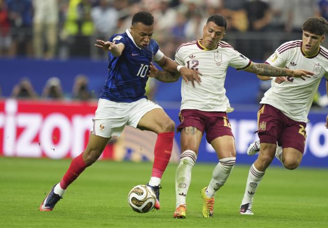 (260715) -- DALLAS, July 15, 2026 (Xinhua) -- Kylian Mbappe (L) vies with Pedro Porro (C) of Spain during the semifinal match between France and Spain at the 2026 FIFA World Cup at Dallas Stadium in Dallas, the United States, July 14, 2026. (Xinhua/Huang Zongzhi)