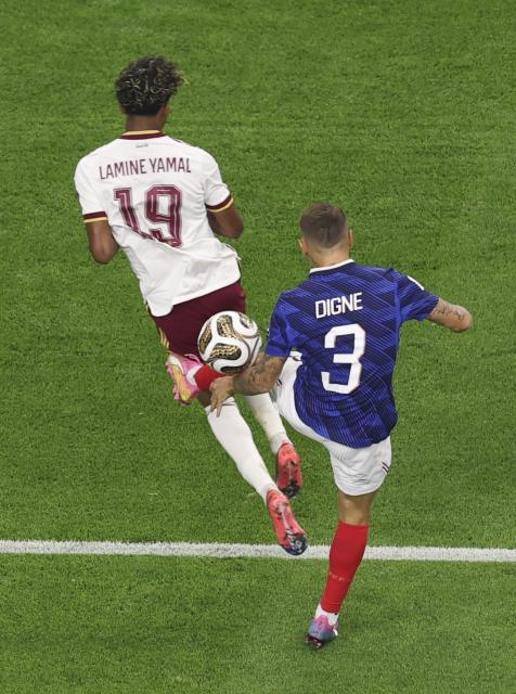 (260715) -- DALLAS, July 15, 2026 (Xinhua) -- Lucas Digne (R) of France fouls Lamine Yamal of Spain during the semifinal match between France and Spain at the 2026 FIFA World Cup at Dallas Stadium in Dallas, the United States, July 14, 2026. (Xinhua/Hu Xingyu)