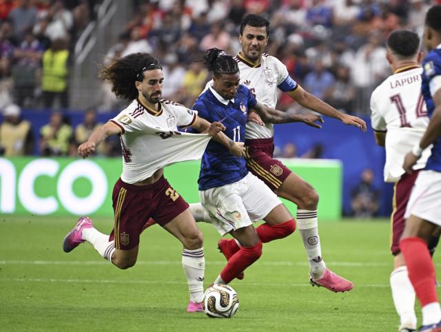 (260715) -- DALLAS, July 15, 2026 (Xinhua) -- Michael Olise (C) of France vies with Marc Cucurella (L) of Spain during the semifinal match between France and Spain at the 2026 FIFA World Cup at Dallas Stadium in Dallas, the United States, July 14, 2026. (Xinhua/Chen Yichen)