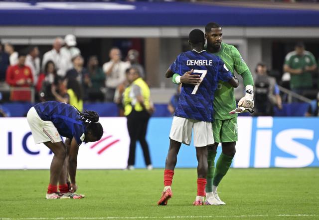 (260715) -- DALLAS, July 15, 2026 (Xinhua) -- Ousmane Dembele (C) of France hugs goalkeeper Mike Maignan (R) after the semifinal match between France and Spain at the 2026 FIFA World Cup at Dallas Stadium in Dallas, the United States, July 14, 2026. (Xinhua/Chen Yichen)