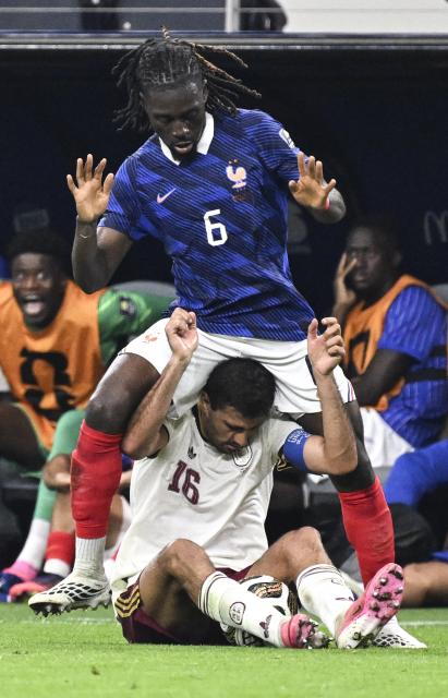(260715) -- DALLAS, July 15, 2026 (Xinhua) -- Manu Kone (top) of France vies with Rodri of Spain during the semifinal match between France and Spain at the 2026 FIFA World Cup at Dallas Stadium in Dallas, the United States, July 14, 2026. (Xinhua/Chen Yichen)