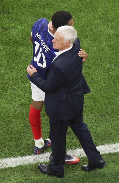 (260715) -- DALLAS, July 15, 2026 (Xinhua) -- Didier Deschamps (R), head coach of France, hugs Kylian Mbappe after the semifinal match between France and Spain at the 2026 FIFA World Cup at Dallas Stadium in Dallas, the United States, July 14, 2026. (Xinhua/Hu Xingyu)