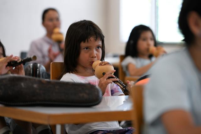 (260715) -- BERN, July 15, 2026 (Xinhua) -- A child learns to play the Hulusi, a traditional Chinese wind instrument, during a Chinese culture summer camp in Bern, Switzerland, July 14, 2026. A summer camp featuring traditional Chinese culture opened here on Tuesday. (Xinhua/Lian Yi)