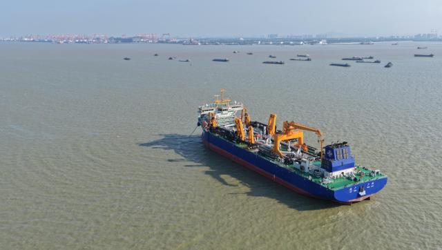 (260715) -- GUANGZHOU, July 15, 2026 (Xinhua) -- An aerial drone photo taken on May 27, 2026 shows the "Junguang" dredger at the Pearl River Estuary area, in south China's Guangdong Province. The "Junguang," a mega dredger with a 35,000 cubic meter capacity, was recently put into operation. Measuring 198 meters in length, with a maximum dredging depth of 120 meters and a deadweight of 60,483 tonnes, the vessel is the largest of its kind in Asia. 
  The vessel is equipped with the self-developed intelligent dredging control systems. It is capable of exceptional performance, including strong soil penetration, deep dredging, long-distance transport, and extended blowing capabilities. It is expected to be widely used in port and waterway dredging, deep-sea sand extraction, land reclamation, deep-sea mining, trench excavation and backfilling, gravel bed construction, and deep-sea pipeline laying. (Xinhua/Deng Hua)