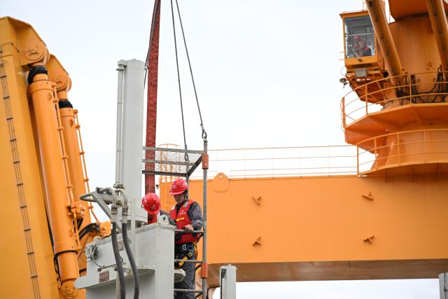(260715) -- GUANGZHOU, July 15, 2026 (Xinhua) -- Staff members work on the "Junguang" dredger on July 14, 2026. The "Junguang," a mega dredger with a 35,000 cubic meter capacity, was recently put into operation. Measuring 198 meters in length, with a maximum dredging depth of 120 meters and a deadweight of 60,483 tonnes, the vessel is the largest of its kind in Asia. 
  The vessel is equipped with the self-developed intelligent dredging control systems. It is capable of exceptional performance, including strong soil penetration, deep dredging, long-distance transport, and extended blowing capabilities. It is expected to be widely used in port and waterway dredging, deep-sea sand extraction, land reclamation, deep-sea mining, trench excavation and backfilling, gravel bed construction, and deep-sea pipeline laying. (Xinhua/Deng Hua)