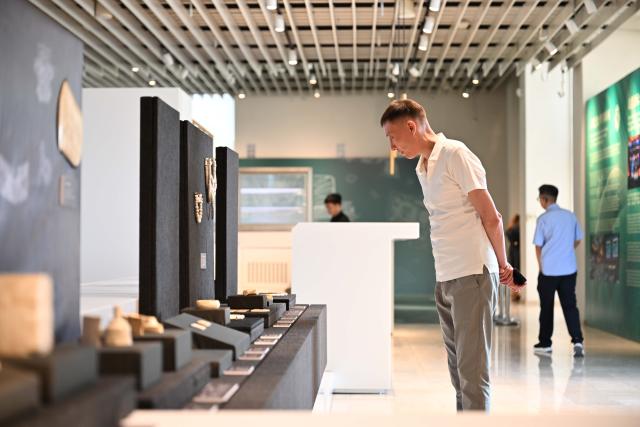 (260715) -- BISHKEK, July 15, 2026 (Xinhua) -- People visit a digital archaeological exhibition showcasing the ancient Chinese Liangzhu culture during the 2026 Shanghai Cooperation Organization (SCO) Dialogue of Civilizations in Bishkek, the capital of Kyrgyzstan, July 14, 2026. The event was held on Tuesday in Bishkek, where around 200 representatives from governments, media, cultural institutions and academia across SCO member states underscored the importance of dialogue and mutual learning among civilizations. (Xinhua/Li Renzi)