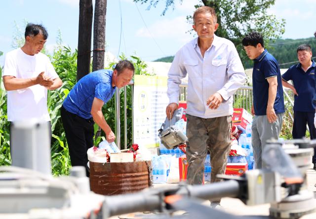 (260715) -- KAIYUAN, July 15, 2026 (Xinhua) -- Staff members prepare relief supplies to be delivered by drones in Huangqizhai Village of Kaiyuan City, northeast China's Liaoning Province, July 15, 2026. On Tuesday, China's national commission for disaster prevention, reduction and relief activated a Level-IV national disaster relief emergency response for Liaoning Province, which was hit by rainstorms and flooding.
   China has a four-tier emergency response system, with Level I being the most severe. (Xinhua/Han He)