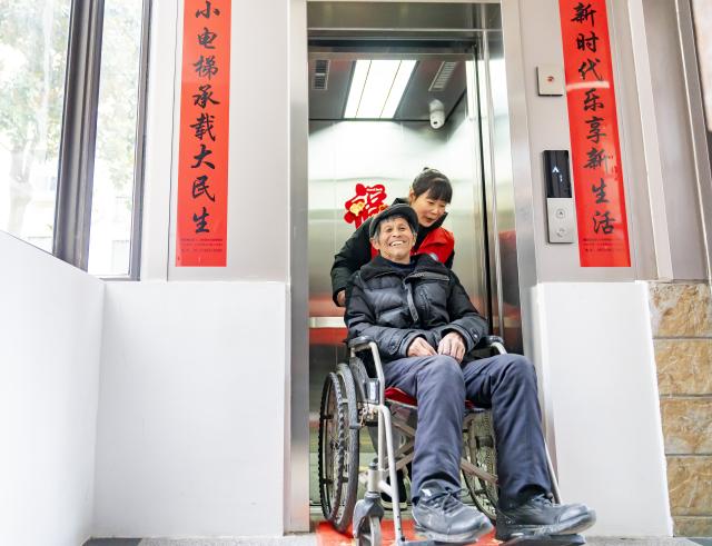 (260715) -- BEIJING, July 15, 2026 (Xinhua) -- Residents take a newly built elevator at a residential compound in Nantong City, east China's Jiangsu Province, March 4, 2026. During China's 14th Five-Year Plan period (2021-2025), over 240,000 old urban residential compounds were renovated across the country, benefiting more than 40 million households and 110 million residents.
   Under urban renewal initiatives, 129,000 elevators have been installed, over 3.4 million parking spaces have been added, and 64,000 residential compound service facilities providing services such as senior and child care have been constructed.
   Entering the 15th Five-Year Plan period (2026-2030), China schedules to start the renovation work of another 115,000 old urban residential compounds, in an effort to inject new development vitality into old neighborhoods. (Photo by Zhai Huiyong/Xinhua)