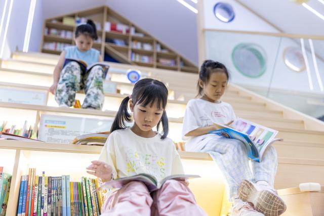 (260715) -- BEIJING, July 15, 2026 (Xinhua) -- Children read books during a summer day camp at a residential compound in Wuxing District of Huzhou City, east China's Zhejiang Province, July 6, 2026. During China's 14th Five-Year Plan period (2021-2025), over 240,000 old urban residential compounds were renovated across the country, benefiting more than 40 million households and 110 million residents.
   Under urban renewal initiatives, 129,000 elevators have been installed, over 3.4 million parking spaces have been added, and 64,000 residential compound service facilities providing services such as senior and child care have been constructed.
   Entering the 15th Five-Year Plan period (2026-2030), China schedules to start the renovation work of another 115,000 old urban residential compounds, in an effort to inject new development vitality into old neighborhoods. (Photo by Yi Fan/Xinhua)