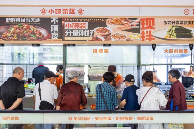 (260715) -- BEIJING, July 15, 2026 (Xinhua) -- Residents select dishes at a canteen of a residential compound in Wenling City, east China's Zhejiang Province, July 14, 2026. During China's 14th Five-Year Plan period (2021-2025), over 240,000 old urban residential compounds were renovated across the country, benefiting more than 40 million households and 110 million residents.
   Under urban renewal initiatives, 129,000 elevators have been installed, over 3.4 million parking spaces have been added, and 64,000 residential compound service facilities providing services such as senior and child care have been constructed.
   Entering the 15th Five-Year Plan period (2026-2030), China schedules to start the renovation work of another 115,000 old urban residential compounds, in an effort to inject new development vitality into old neighborhoods. (Photo by Xu Weijie/Xinhua)
