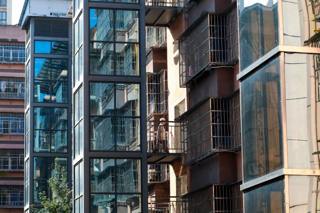 (260715) -- BEIJING, July 15, 2026 (Xinhua) -- A resident walks out of a newly built elevator at an old residential compound in Duyun City, southwest China's Guizhou Province, July 14, 2026. During China's 14th Five-Year Plan period (2021-2025), over 240,000 old urban residential compounds were renovated across the country, benefiting more than 40 million households and 110 million residents.
   Under urban renewal initiatives, 129,000 elevators have been installed, over 3.4 million parking spaces have been added, and 64,000 residential compound service facilities providing services such as senior and child care have been constructed.
   Entering the 15th Five-Year Plan period (2026-2030), China schedules to start the renovation work of another 115,000 old urban residential compounds, in an effort to inject new development vitality into old neighborhoods. (Photo by Xiao Wei/Xinhua)