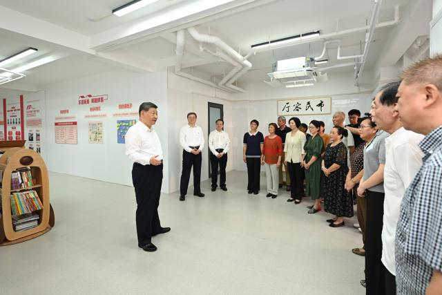 (260715) -- SHANGHAI, July 15, 2026 (Xinhua) -- Chinese President Xi Jinping, also general secretary of the Communist Party of China (CPC) Central Committee and chairman of the Central Military Commission, talks with residents, subdistrict officials and community workers at a residential community in Huangpu District, Shanghai, east China, July 15, 2026. Xi made an inspection trip to Shanghai on Wednesday. (Xinhua/Xie Huanchi)