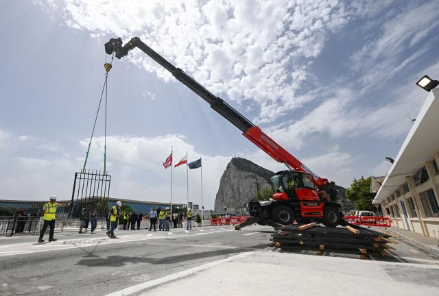 (260715) -- GIBRALTAR, July 15, 2026 (Xinhua) -- Workers dismantle the border fence with a crane at the Spain-Gibraltar land crossing on July 15, 2026. Routine border checks at the Spain-Gibraltar land crossing were lifted in the early hours of Wednesday, in line with new border arrangements under the post-Brexit agreement between the European Union and Britain.
The agreement, signed in Brussels on Tuesday, began provisional application on Wednesday and remains subject to the consent of the European Parliament and the completion of ratification procedures by both sides. (Xinhua/Cheng Min)