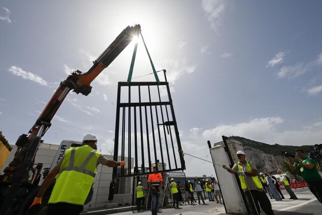 (260715) -- GIBRALTAR, July 15, 2026 (Xinhua) -- A border check fence is lifted at the land border crossing between Gibraltar and Spain, on July 15, 2026. Routine border checks at the Spain-Gibraltar land crossing were lifted in the early hours of Wednesday, in line with new border arrangements under the post-Brexit agreement between the European Union and Britain.
   The agreement, signed in Brussels on Tuesday, began provisional application on Wednesday and remains subject to the consent of the European Parliament and the completion of ratification procedures by both sides. (Xinhua/Cheng Min)